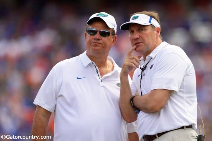 University of Florida defensive line coach Sal Sunseri confers with head coach Dan Mullen during the 2018 Orange and Blue game- Florida Gators football- 1280x853