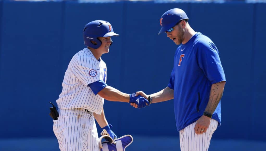 University of Florida infielder Blake Reese shakes Lars Davis’ hand after a single against Auburn- Florida Gators baseball- 1280x853