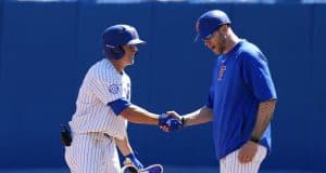 University of Florida infielder Blake Reese shakes Lars Davis’ hand after a single against Auburn- Florida Gators baseball- 1280x853