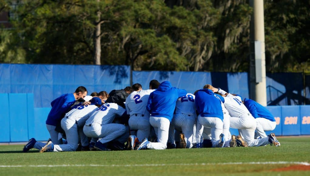 The University of Florida Gators baseball team says a group prayer before their game against the Florida State Seminoles- Florida Gators baseball- 1280x853