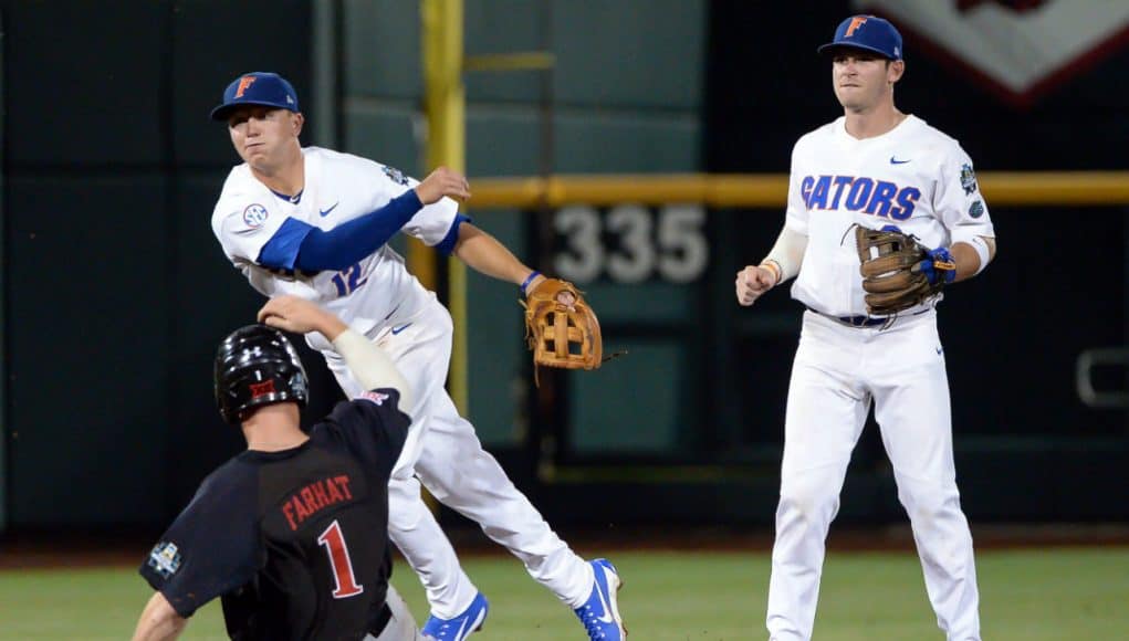 Jun 17, 2018; Omaha, NE, USA; Texas Tech Red Raiders center fielder Cody Farhat (1) slides into second base as Florida Gators second baseman Blake Reese (12) completes a double play with shortstop Deacon Liput (8) watching in the third inning during the College World Series at TD Ameritrade Park. Mandatory Credit: Steven Branscombe-USA TODAY Sports