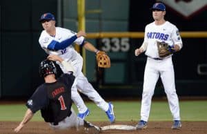 Jun 17, 2018; Omaha, NE, USA; Texas Tech Red Raiders center fielder Cody Farhat (1) slides into second base as Florida Gators second baseman Blake Reese (12) completes a double play with shortstop Deacon Liput (8) watching in the third inning during the College World Series at TD Ameritrade Park. Mandatory Credit: Steven Branscombe-USA TODAY Sports