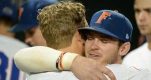 Jun 22, 2018; Omaha, NE, USA; Florida Gators second baseman Blake Reese (12) and shortstop Deacon Liput (8) hug after the loss against the Arkansas Razorbacks in the College World Series at TD Ameritrade Park. Mandatory Credit: Steven Branscombe-USA TODAY Sports