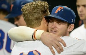 Jun 22, 2018; Omaha, NE, USA; Florida Gators second baseman Blake Reese (12) and shortstop Deacon Liput (8) hug after the loss against the Arkansas Razorbacks in the College World Series at TD Ameritrade Park. Mandatory Credit: Steven Branscombe-USA TODAY Sports