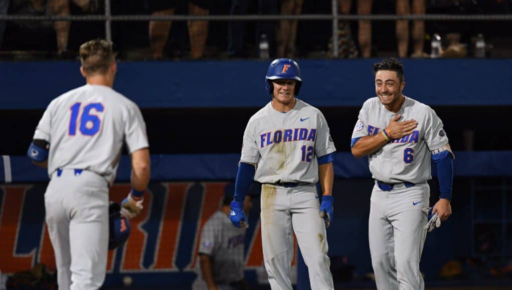 University of Florida third baseman Jonathan India and Blake Reese meet Wil Dalton at the plate after his home run against Jacksonville in the Gainesville Regional- Florida Gators baseball- 1280x853