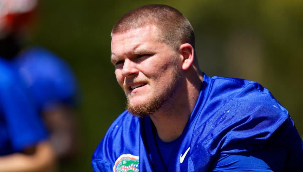 University of Florida offensive guard Brett Heggie takes a knee while Dan Mullen addresses the Florida Gators after their second spring practice- Florida Gators football- 1280x853