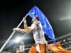 Florida Gators quarterback Feleipe Franks carries the Florida flag after defeating Mississippi State- 1280x854