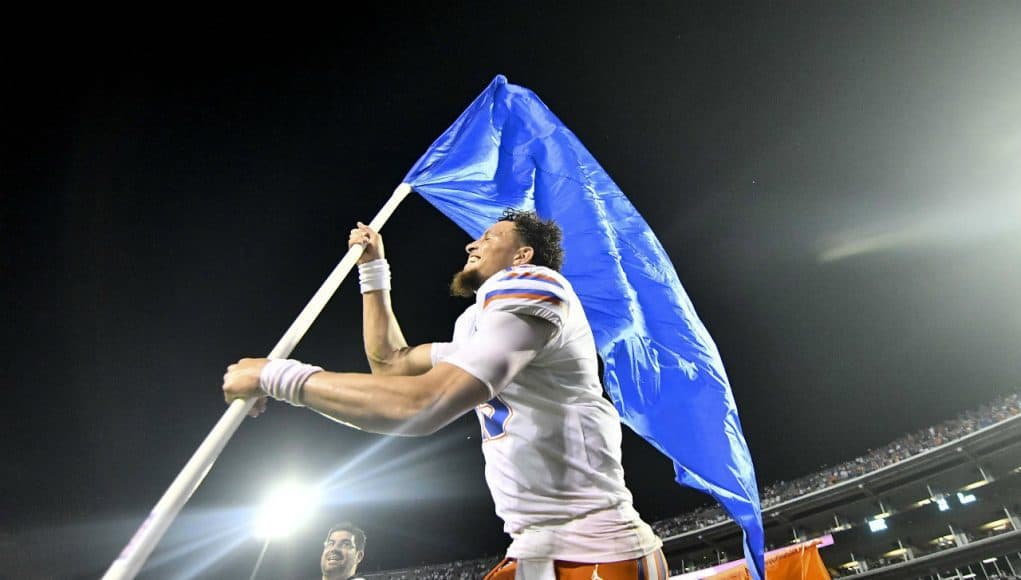 Florida Gators quarterback Feleipe Franks carries the Florida flag after defeating Mississippi State- 1280x854