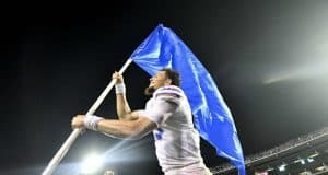 Florida Gators quarterback Feleipe Franks carries the Florida flag after defeating Mississippi State- 1280x854