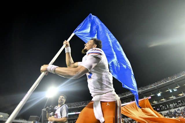 Florida Gators quarterback Feleipe Franks carries the Florida flag after defeating Mississippi State- 1280x854