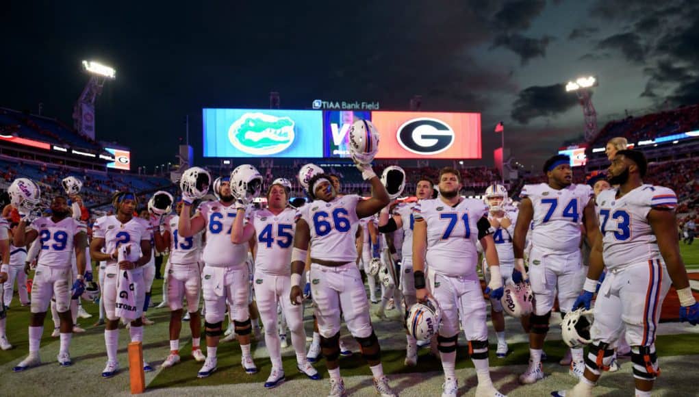 University of Florida football players stand on the field and sing the alma mater after a 36-17 loss to the Georgia Bulldogs- Florida Gators football- 1280x852