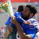 Florida Gators defensive lineman Cece Jefferson holds his son during senior day- 1280x1024