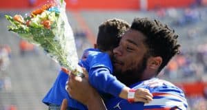 Florida Gators defensive lineman Cece Jefferson holds his son during senior day- 1280x1024