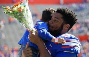 Florida Gators defensive lineman Cece Jefferson holds his son during senior day- 1280x1024