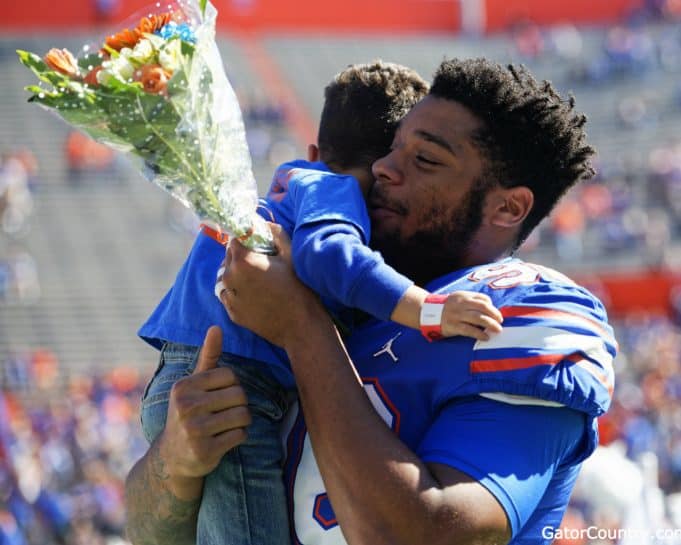 Florida Gators defensive lineman Cece Jefferson holds his son during senior day- 1280x1024