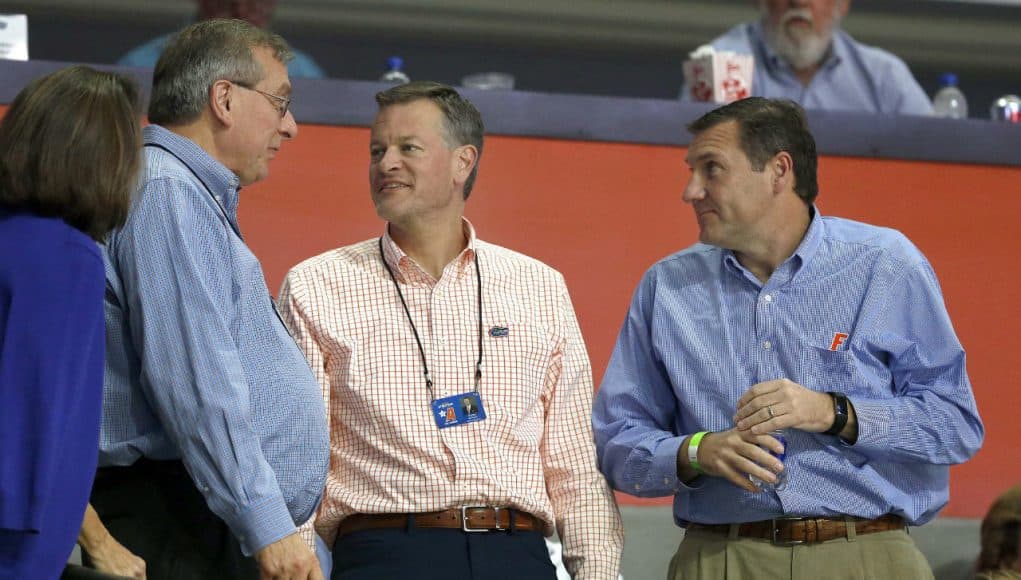 Dec 20, 2017; Gainesville, FL, USA; Florida Gators president Kent Fuchs, athletic director Scott Stricklin, and head football coach Dan Mullen talks during the second half against the James Madison Dukes at Exactech Arena at the Stephen C. O'Connell Center. Mandatory Credit: Kim Klement-USA TODAY Sports