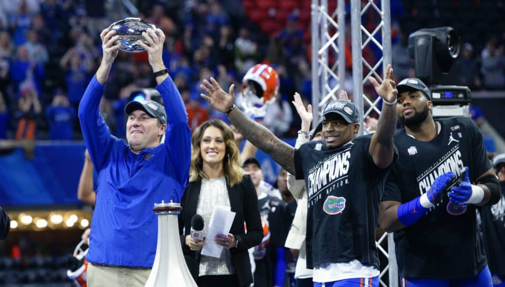 Florida Gators head coach Dan Mullen holds the Peach Bowl trophy-1280x853