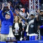 Florida Gators head coach Dan Mullen holds the Peach Bowl trophy-1280x853