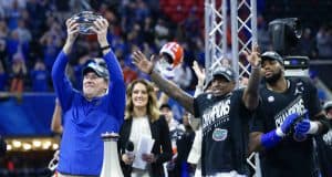 Florida Gators head coach Dan Mullen holds the Peach Bowl trophy-1280x853