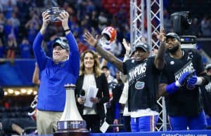 Florida Gators head coach Dan Mullen holds the Peach Bowl trophy-1280x853