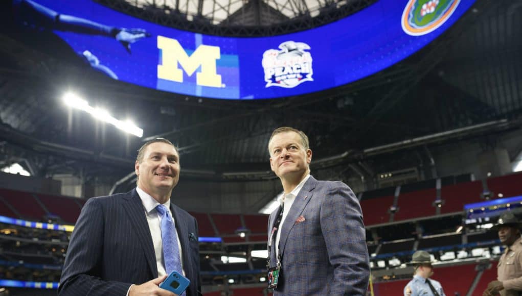 University of Florida football coach Dan Mullen and UF Athletic Director Scott Stricklin talking on the field before the 2018 Peach Bowl- Florida Gators football- 1280x852