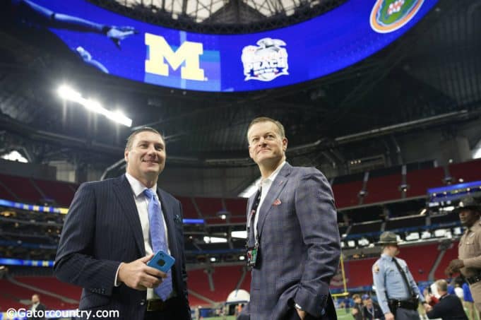 University of Florida football coach Dan Mullen and UF Athletic Director Scott Stricklin talking on the field before the 2018 Peach Bowl- Florida Gators football- 1280x852