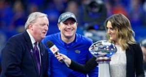University of Florida head coach Dan Mullen accepts the Chick-fil-A Peach Bowl trophy after the Gators’ 41-15 win over Michigan- Florida Gators football- 1280x853