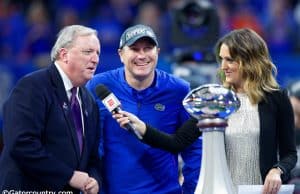 University of Florida head coach Dan Mullen accepts the Chick-fil-A Peach Bowl trophy after the Gators’ 41-15 win over Michigan- Florida Gators football- 1280x853