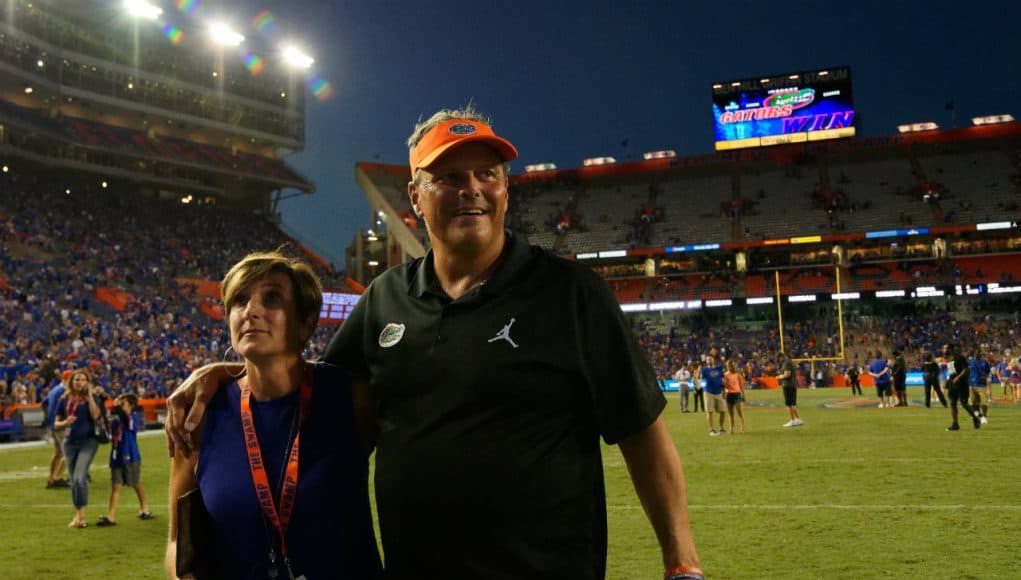 University of Florida defensive coordinator walks off the field with his wife Paige after the Florida Gators win over LSU- Florida Gators football- 1280x852