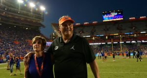 University of Florida defensive coordinator walks off the field with his wife Paige after the Florida Gators win over LSU- Florida Gators football- 1280x852