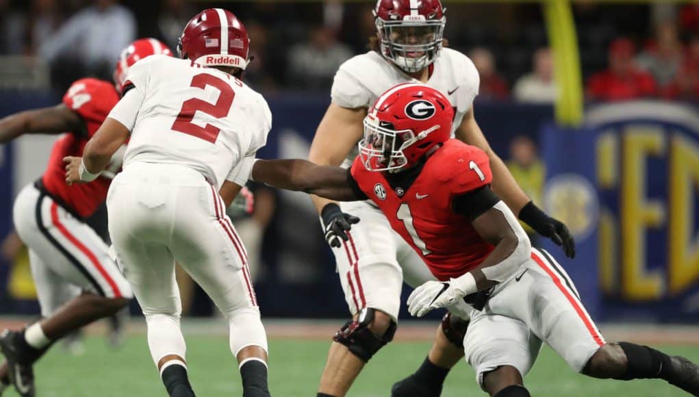 Dec 1, 2018; Atlanta, GA, USA; Alabama Crimson Tide quarterback Jalen Hurts (2) gets by the tackle attempt by Georgia Bulldogs linebacker Brenton Cox (1) in the SEC championship game at Mercedes-Benz Stadium. Mandatory Credit: Jason Getz-USA TODAY Sports