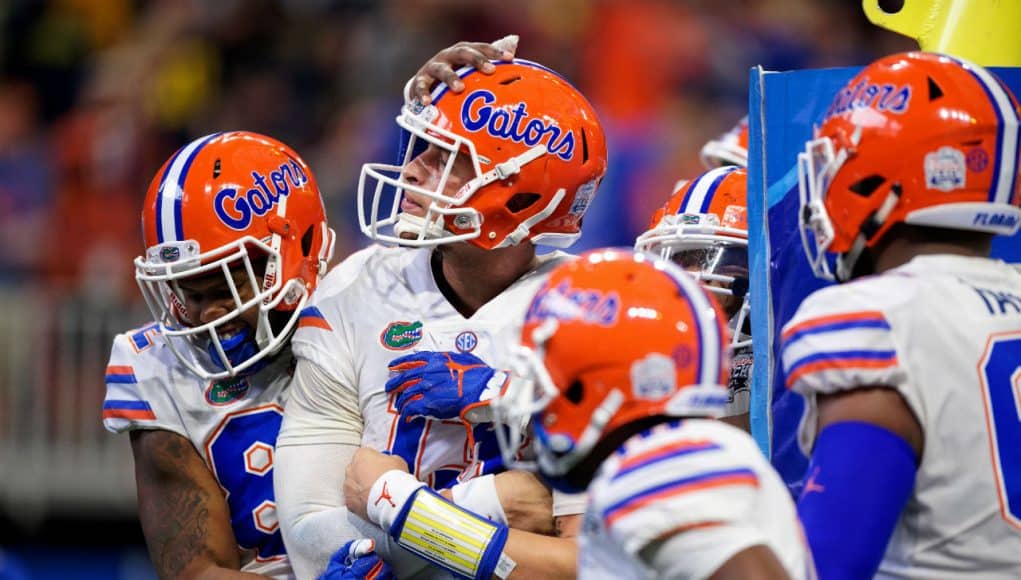 University of Florida quarterback Feleipe Franks is mobbed by teammates after scoring a touchdown against Michigan in the Peach Bowl- Florida Gators football- 1280x853