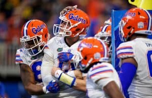 University of Florida quarterback Feleipe Franks is mobbed by teammates after scoring a touchdown against Michigan in the Peach Bowl- Florida Gators football- 1280x853