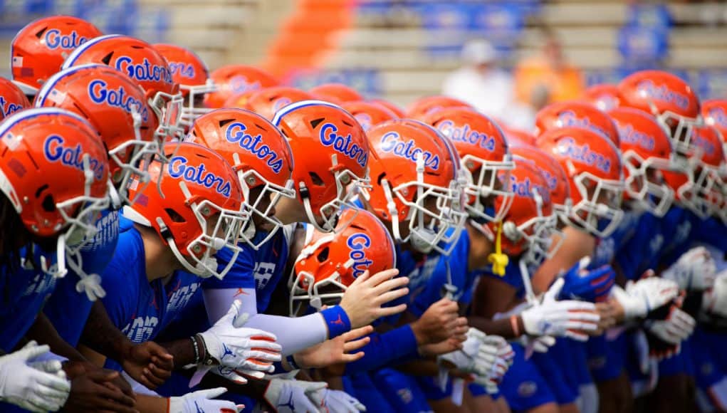 The University of Florida football team locks arms and begins warming up before the Florida Gator game against the Tennessee Volunteers- Florida Gators football- 1280x853