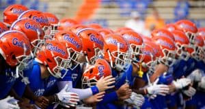The University of Florida football team locks arms and begins warming up before the Florida Gator game against the Tennessee Volunteers- Florida Gators football- 1280x853