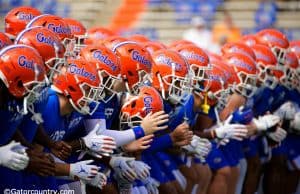 The University of Florida football team locks arms and begins warming up before the Florida Gator game against the Tennessee Volunteers- Florida Gators football- 1280x853