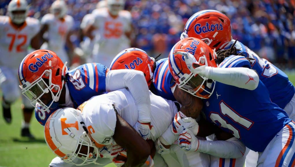 University of Florida defensive players gang tackle a Tennessee receiver in a 34-3 win over the Volunteers- Florida Gators football- 1280x853