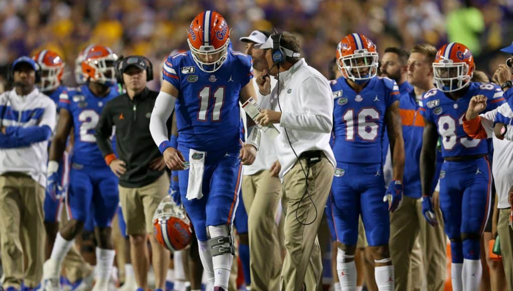 Oct 12, 2019; Baton Rouge, LA, USA; Florida Gators head coach Dan Mullen talks to quarterback Kyle Trask (11) in the first quarter of their game against the LSU Tigers at Tiger Stadium. Mandatory Credit: Chuck Cook-USA TODAY Sports