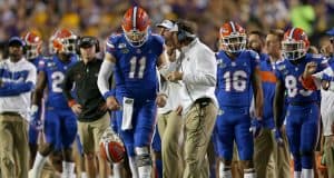 Oct 12, 2019; Baton Rouge, LA, USA; Florida Gators head coach Dan Mullen talks to quarterback Kyle Trask (11) in the first quarter of their game against the LSU Tigers at Tiger Stadium. Mandatory Credit: Chuck Cook-USA TODAY Sports