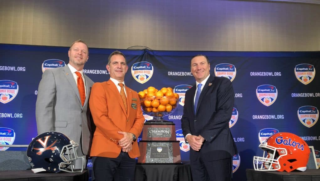 Head coaches Bronco Mendenhall and Dan Mullen pose with Orange Bowl committee president José Romano and the Orange Bowl trophy- Florida Gators football- 1280x960
