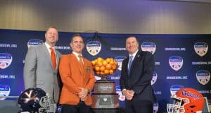 Head coaches Bronco Mendenhall and Dan Mullen pose with Orange Bowl committee president José Romano and the Orange Bowl trophy- Florida Gators football- 1280x960
