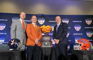 Head coaches Bronco Mendenhall and Dan Mullen pose with Orange Bowl committee president José Romano and the Orange Bowl trophy- Florida Gators football- 1280x960