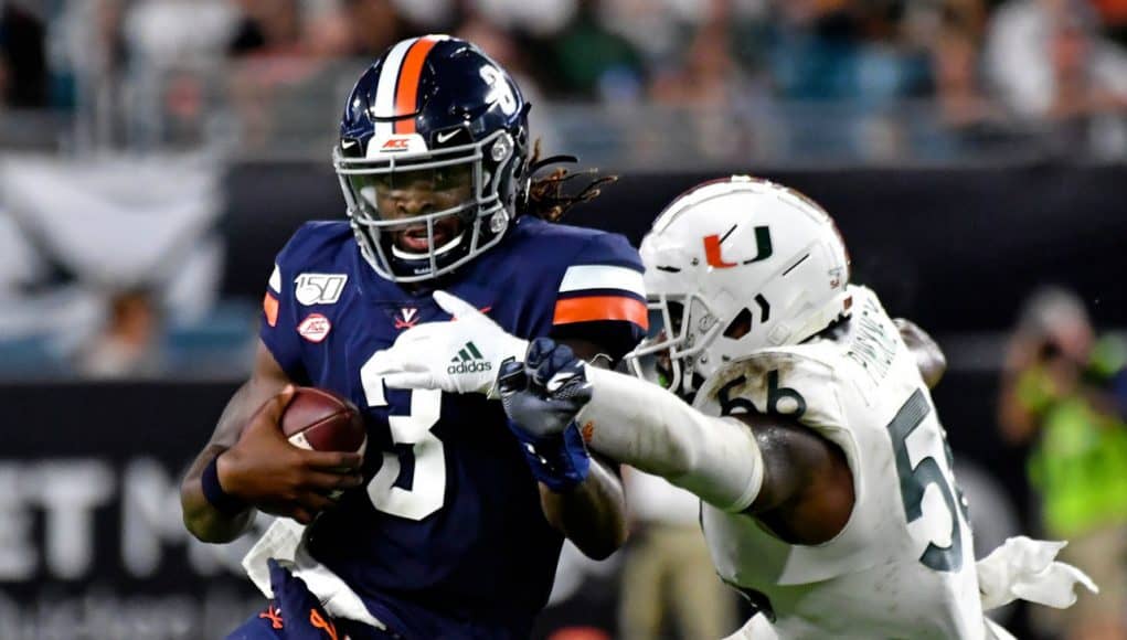 Oct 11, 2019; Miami Gardens, FL, USA; Virginia Cavaliers quarterback Bryce Perkins (3) is tackled by Miami Hurricanes linebacker Michael Pinckney (56) during the second half at Hard Rock Stadium. Mandatory Credit: Steve Mitchell-USA TODAY Sports