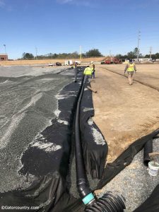 Workers dig trenches to add an irrigation system under the field Florida Gators new baseball stadium- Florida Gators baseball- 1280x1707