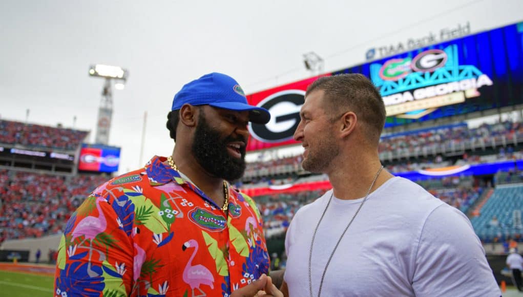 University of Florida alumni Brandon Spikes and Tim Tebow greet each other on the field before the Florida Gators game against Georgia- Florida Gators football - 1250x853