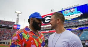 University of Florida alumni Brandon Spikes and Tim Tebow greet each other on the field before the Florida Gators game against Georgia- Florida Gators football - 1250x853