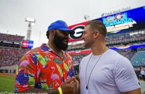 University of Florida alumni Brandon Spikes and Tim Tebow greet each other on the field before the Florida Gators game against Georgia- Florida Gators football - 1250x853