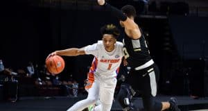 Guard Tre Mann drives against Army-1200x800