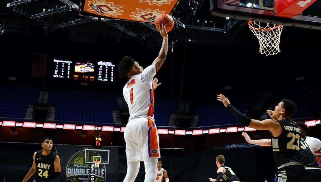 Guard Tre Mann shoots against Army-1200x800