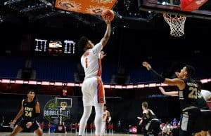 Guard Tre Mann shoots against Army-1200x800